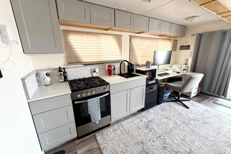 Slide: The Image of Modern kitchen and workspace in 2006 Myacht 4313 houseboat, featuring sleek cabinetry and appliances. - 5