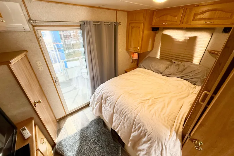 Slide: The Image of Cozy bedroom in 2006 Myacht 4313 houseboat with wooden cabinets and sliding glass door. - 8