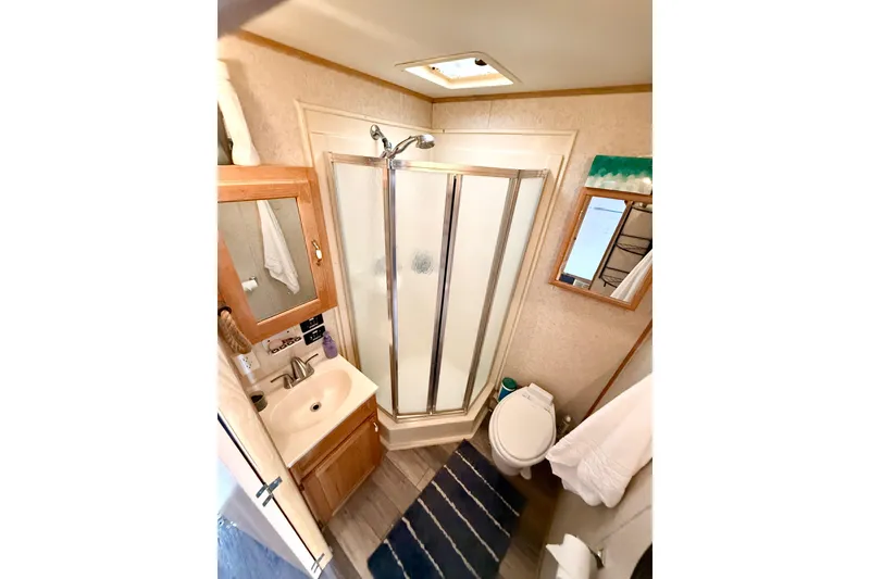 Slide: The Image of Compact bathroom in 2006 Myacht 4313 with shower, sink, and toilet. - 9