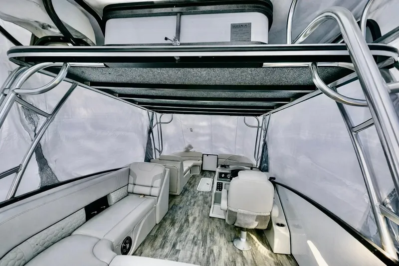 Slide: The Image of 2019 Crest 250 LUSD pontoon boat interior with modern seating and helm. - 13