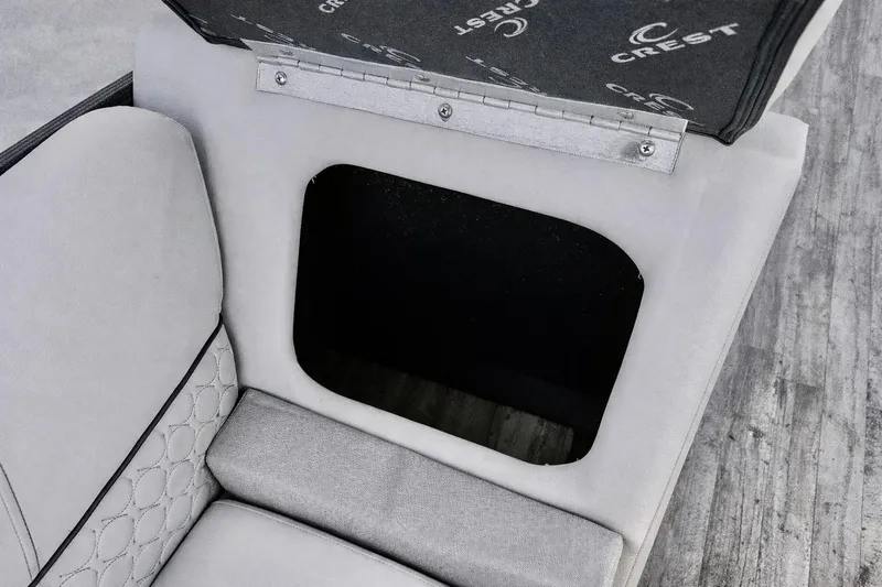 Slide: The Image of Open storage compartment in 2019 Crest 250 LUSD boat seat with quilted upholstery. - 16