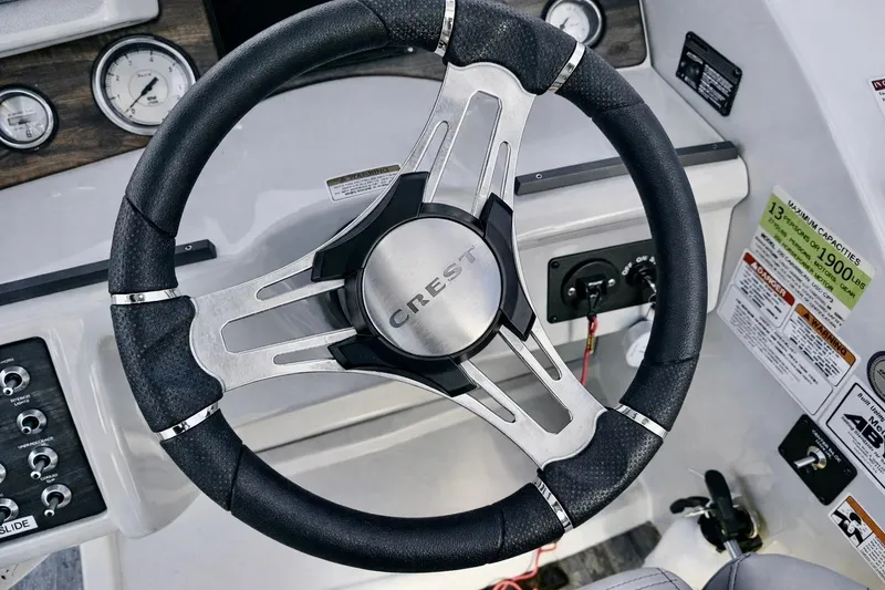Slide: The Image of Steering wheel of 2019 Crest 250 LUSD boat with control panel and gauges. - 21