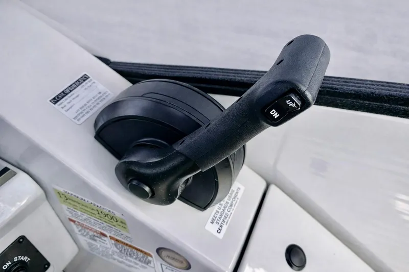 Slide: The Image of Throttle control lever on a 2019 Crest 250 LUSD boat dashboard. - 23