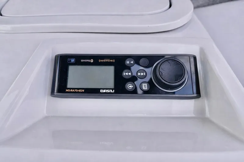 Slide: The Image of Control panel of a 2019 Crest 250 LUSD boat with audio system interface. - 27