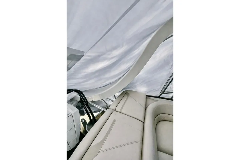 Slide: The Image of Interior of a 2019 Crest 250 LUSD boat with elegant seating and canopy. - 4