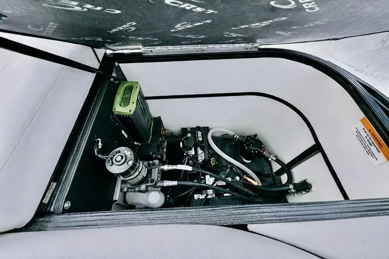 Slide: The Image of 2019 Crest 250 LUSD boat engine compartment with mechanical components and wiring. - 51
