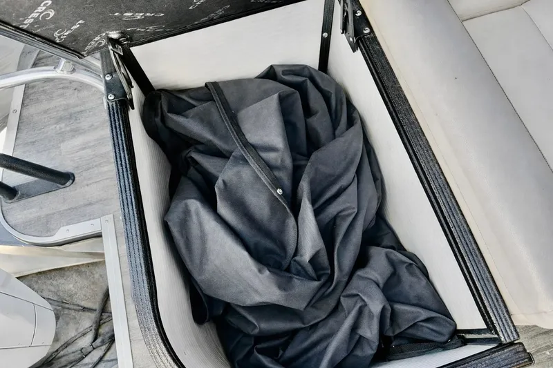 Slide: The Image of Open storage compartment on 2019 Crest 250 LUSD boat with black fabric inside. - 7