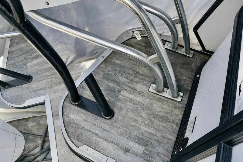 Slide: The Image of 2019 Crest 250 LUSD boat interior with metal railings and wood-textured flooring. - 9