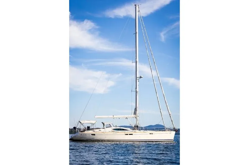 Slide: The Image of 2007 Jeanneau Sun Odyssey 54 DS sailboat on calm water under blue sky. - 13