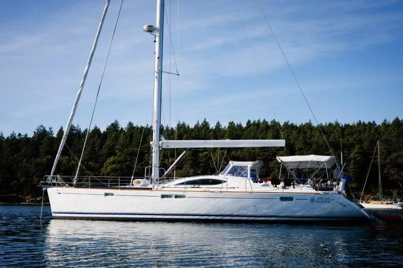 Slide: The Image of 2007 Jeanneau Sun Odyssey 54 DS sailboat on calm water, forested background. - 16