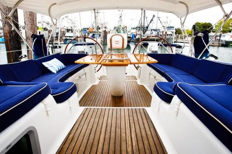 Slide: The Image of Luxurious 2007 Jeanneau Sun Odyssey 54 DS yacht interior with blue seating and wooden deck. - 7