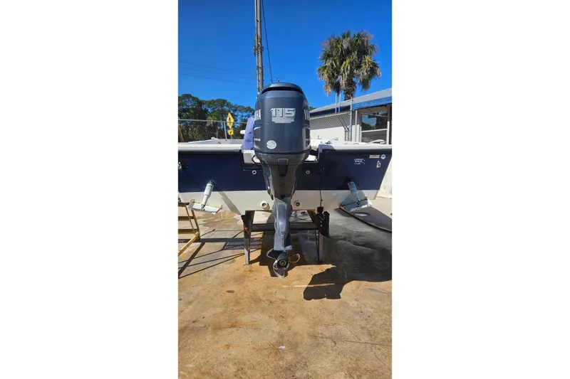 Slide: The Image of 2009 Cobia 191 Bay boat with Yamaha 115 outboard motor, parked outdoors. - 10