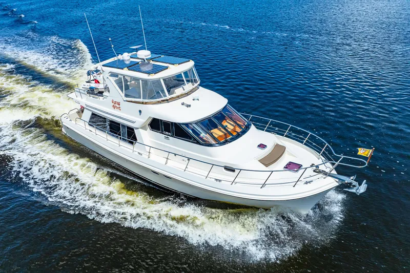 The Image of 2007 Hampton 558 Pilothouse yacht cruising on open water. - 0