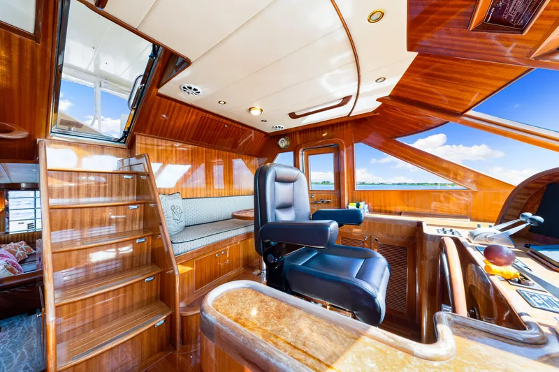Slide: The Image of Luxurious 2007 Hampton 558 Pilothouse interior with polished wood and captain's chair. - 16