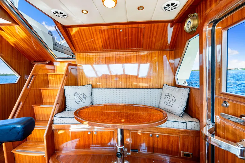 Slide: The Image of Luxurious 2007 Hampton 558 Pilothouse yacht interior with polished wood and nautical decor. - 19