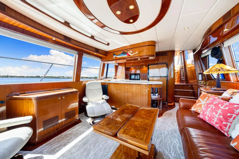 Slide: The Image of Luxurious interior of 2007 Hampton 558 Pilothouse yacht with elegant wood finishes and scenic views. - 24