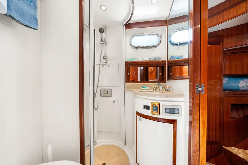 Slide: The Image of Luxurious bathroom in 2007 Hampton 558 Pilothouse yacht with wood accents and modern fixtures. - 39