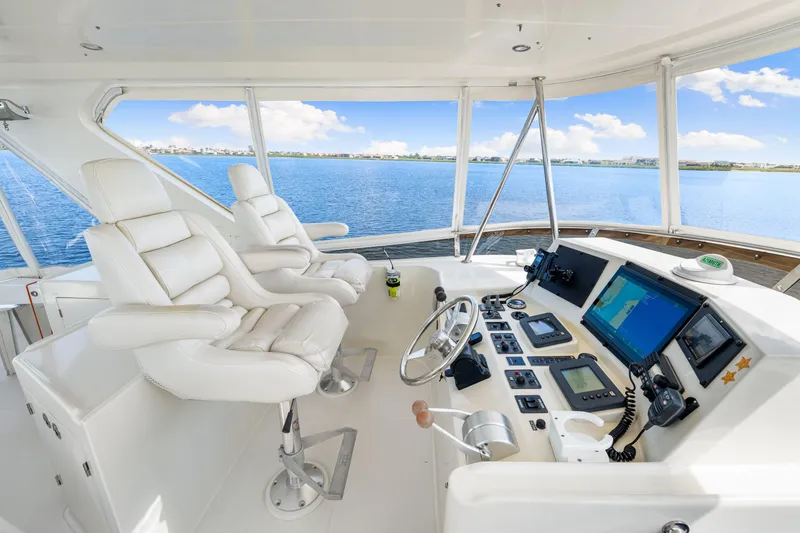 Slide: The Image of Luxurious 2007 Hampton 558 Pilothouse yacht interior with modern navigation equipment and plush seating. - 42