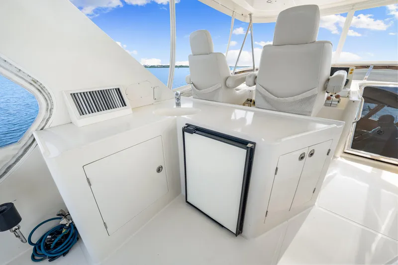 Slide: The Image of 2007 Hampton 558 Pilothouse interior with white seating and cabinetry, overlooking the ocean. - 49