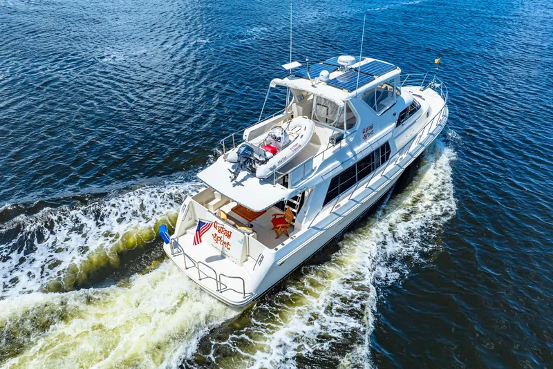 Slide: The Image of 2007 Hampton 558 Pilothouse yacht cruising on open water, aerial view. - 50