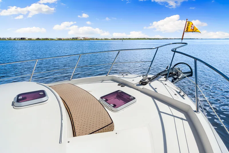 Slide: The Image of 2007 Hampton 558 Pilothouse yacht deck with scenic ocean view and clear blue sky. - 59