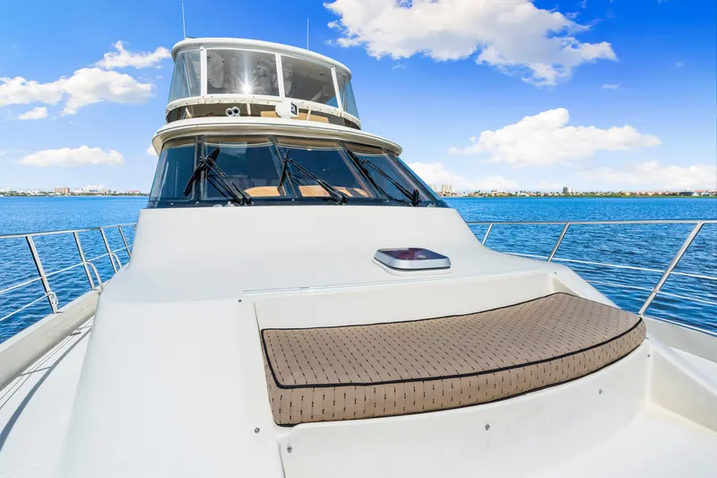 Slide: The Image of 2007 Hampton 558 Pilothouse yacht on calm blue waters under a clear sky. - 63