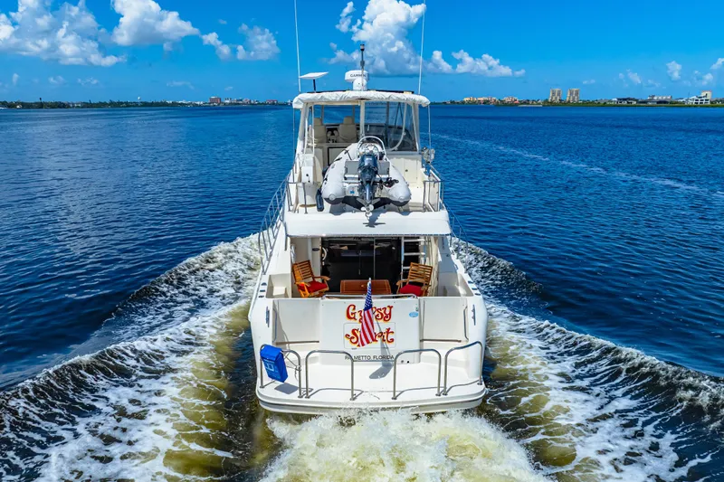 Slide: The Image of 2007 Hampton 558 Pilothouse yacht cruising on a sunny day with clear blue skies. - 66