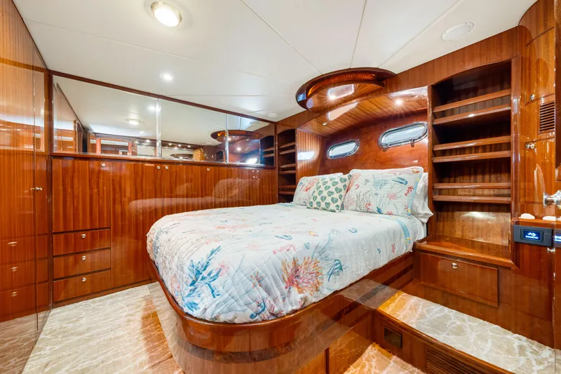 Slide: The Image of Luxurious 2007 Hampton 558 Pilothouse yacht bedroom with elegant wood finish and cozy bedding. - 7