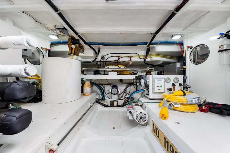 Slide: The Image of Engine room of 2007 Hampton 558 Pilothouse yacht, featuring equipment and wiring. - 71