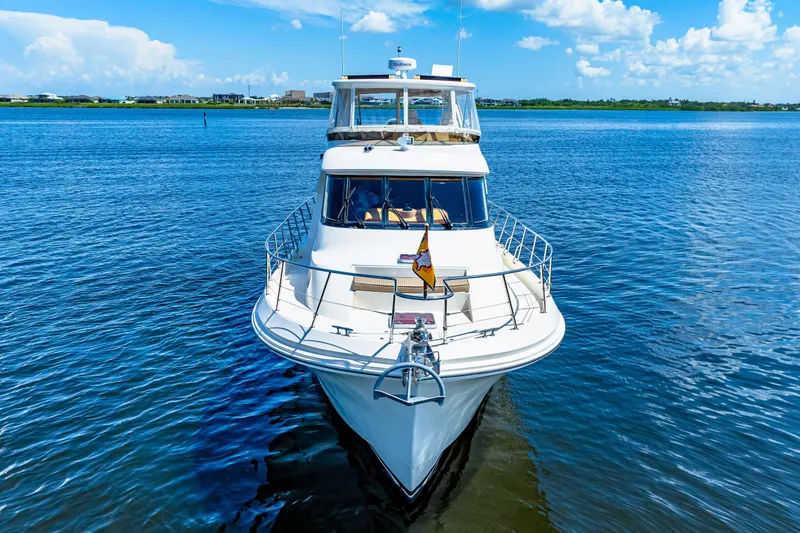Slide: The Image of 2007 Hampton 558 Pilothouse yacht on calm blue water under a clear sky. - 73