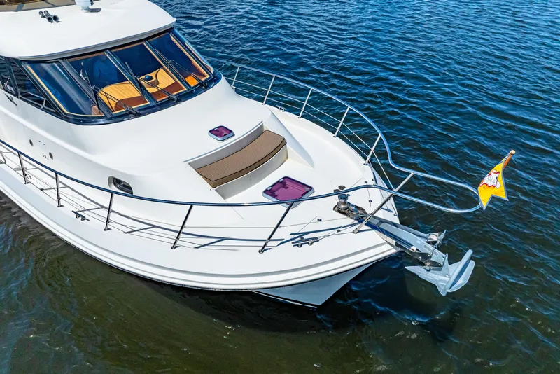 Slide: The Image of 2007 Hampton 558 Pilothouse yacht on calm blue water, showcasing sleek design and deck details. - 79