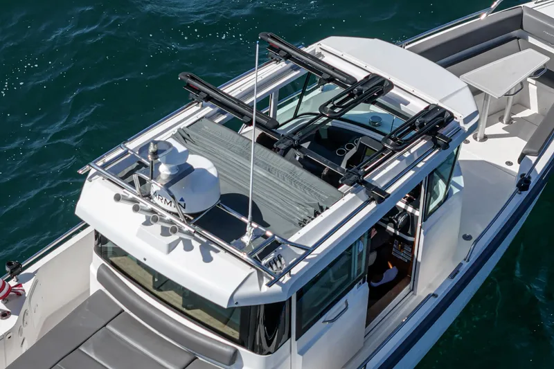 Slide: The Image of 2019 Axopar 28 CABIN boat on water, featuring sleek design and modern equipment. - 18