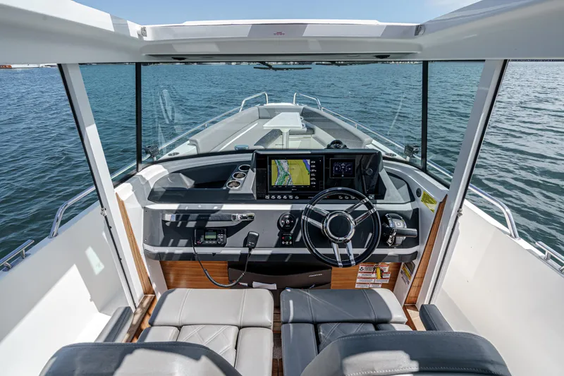 Slide: The Image of Interior view of 2019 Axopar 28 CABIN boat cockpit with navigation system. - 19