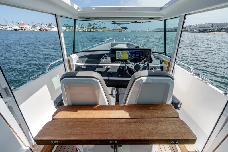 Slide: The Image of Interior view of 2019 Axopar 28 CABIN boat with steering and navigation system. - 20