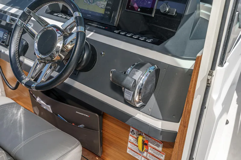 Slide: The Image of Helm of 2019 Axopar 28 CABIN with steering wheel and control panel. - 21