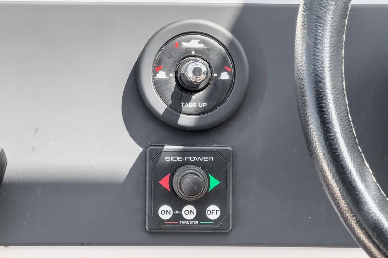 Slide: The Image of Control panel of 2019 Axopar 28 CABIN boat with side-power thruster and trim tabs. - 23