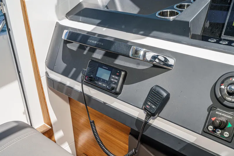 Slide: The Image of Control panel of 2019 Axopar 28 CABIN boat with Garmin radio and microphone. - 24