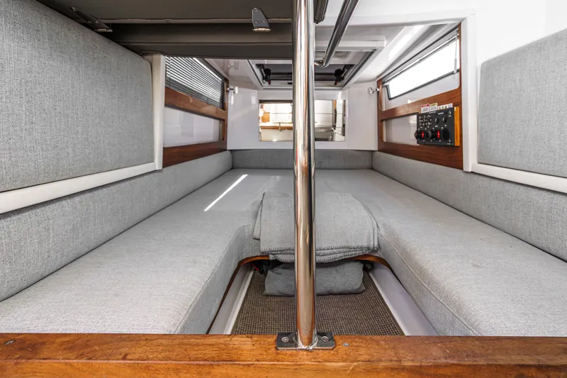 Slide: The Image of Interior of 2019 Axopar 28 CABIN with gray seating and wooden accents. - 32