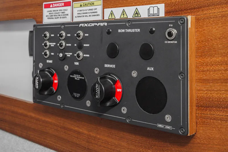 Slide: The Image of Control panel of 2019 Axopar 28 CABIN boat with switches and warning labels. - 33