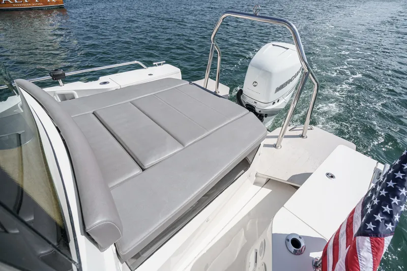 Slide: The Image of 2019 Axopar 28 CABIN boat with cushioned seating and outboard motor on water. - 40