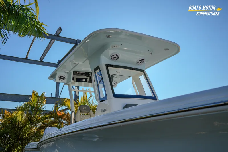 Slide: The Image of 2026 Key West 260 Center Console boat under clear blue sky, surrounded by tropical plants. - 10