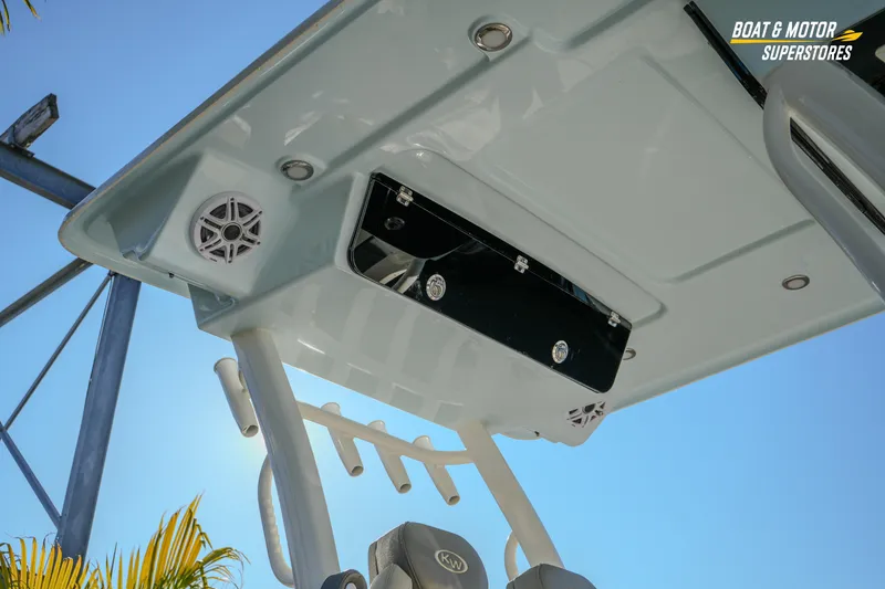 Slide: The Image of 2026 Key West 260 Center Console boat roof with speakers and storage, under clear blue sky. - 14