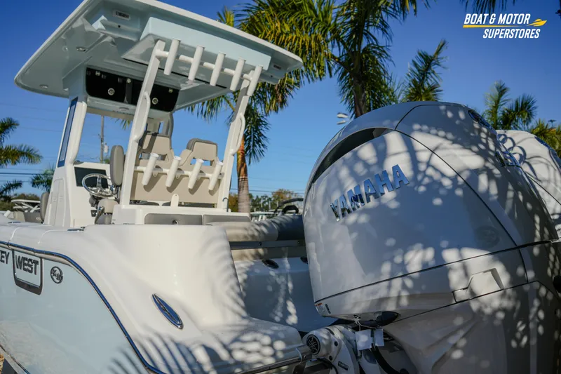 Slide: The Image of 2026 Key West 260 Center Console boat with Yamaha engine, palm trees in background. - 22