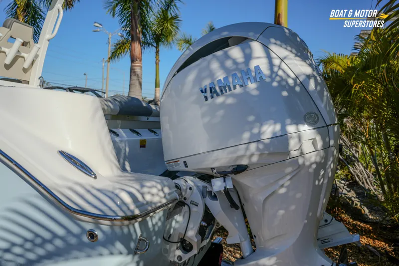 Slide: The Image of 2026 Key West 260 Center Console boat with Yamaha engine, surrounded by palm trees. - 23