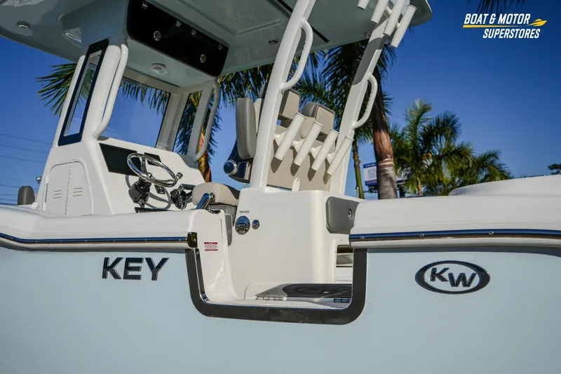 Slide: The Image of 2026 Key West 260 Center Console boat with sleek design and palm trees in background. - 27