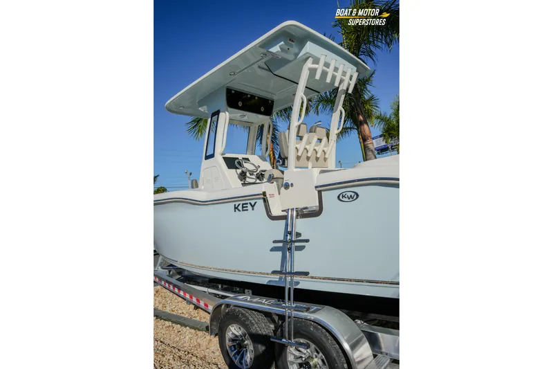 Slide: The Image of 2026 Key West 260 Center Console boat on trailer, palm trees in background. - 28