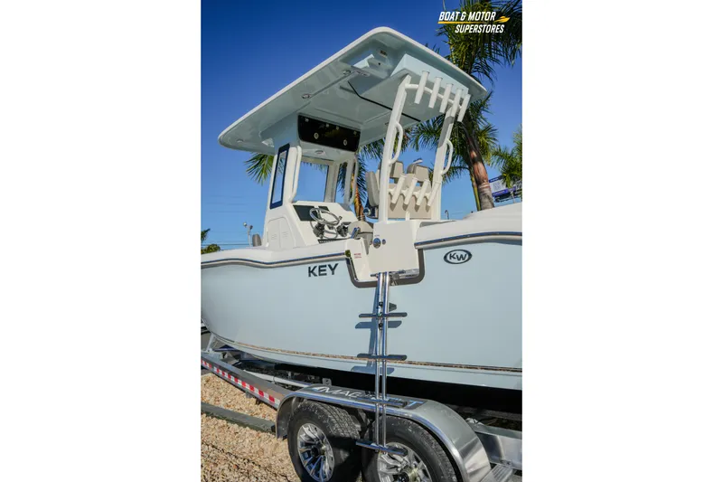 Slide: The Image of 2026 Key West 260 Center Console boat on trailer, palm trees in background. - 29