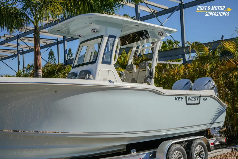 Slide: The Image of 2026 Key West 260 Center Console boat displayed outdoors with palm trees. - 3
