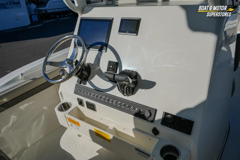 Slide: The Image of 2026 Key West 260 Center Console boat dashboard with steering wheel and controls. - 39