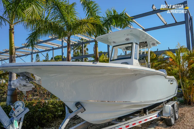 Slide: The Image of 2026 Key West 260 Center Console boat on trailer, surrounded by palm trees. - 4